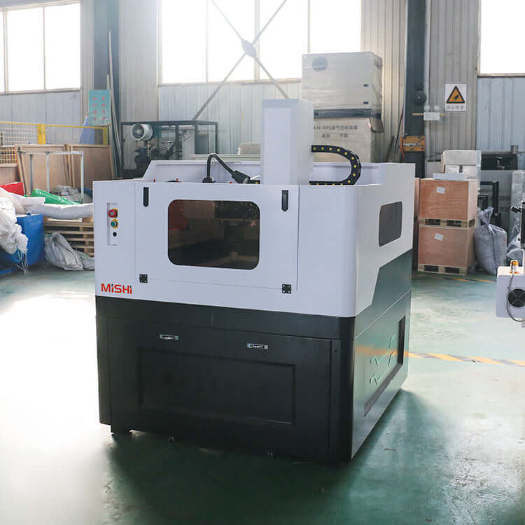 High-precision mini CNC router for metal milling with ball screw transmission and water cooling spindle, in an industrial workshop.