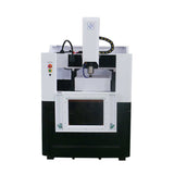 Compact CNC milling machine with black and white design, featuring control panel and spindle, ideal for precision manufacturing.