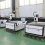 Row of CNC wood engraving machines in a workshop, essential for woodworking and furniture manufacturing efficiency.